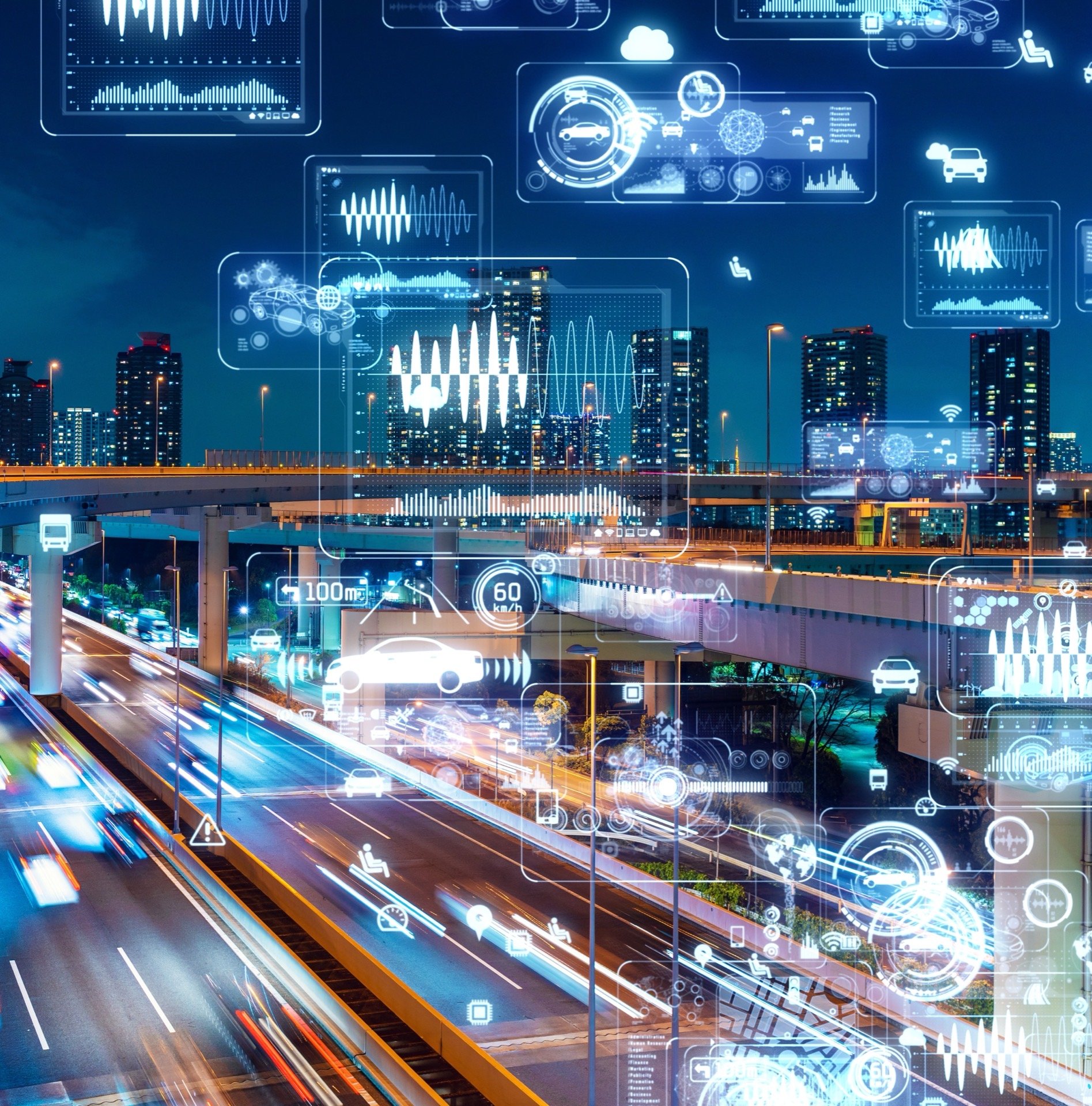 A night-time highway interchange overlaid with connected-vehicle data readouts