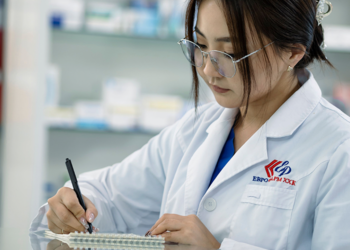 A pharmacist at a dispensing counter