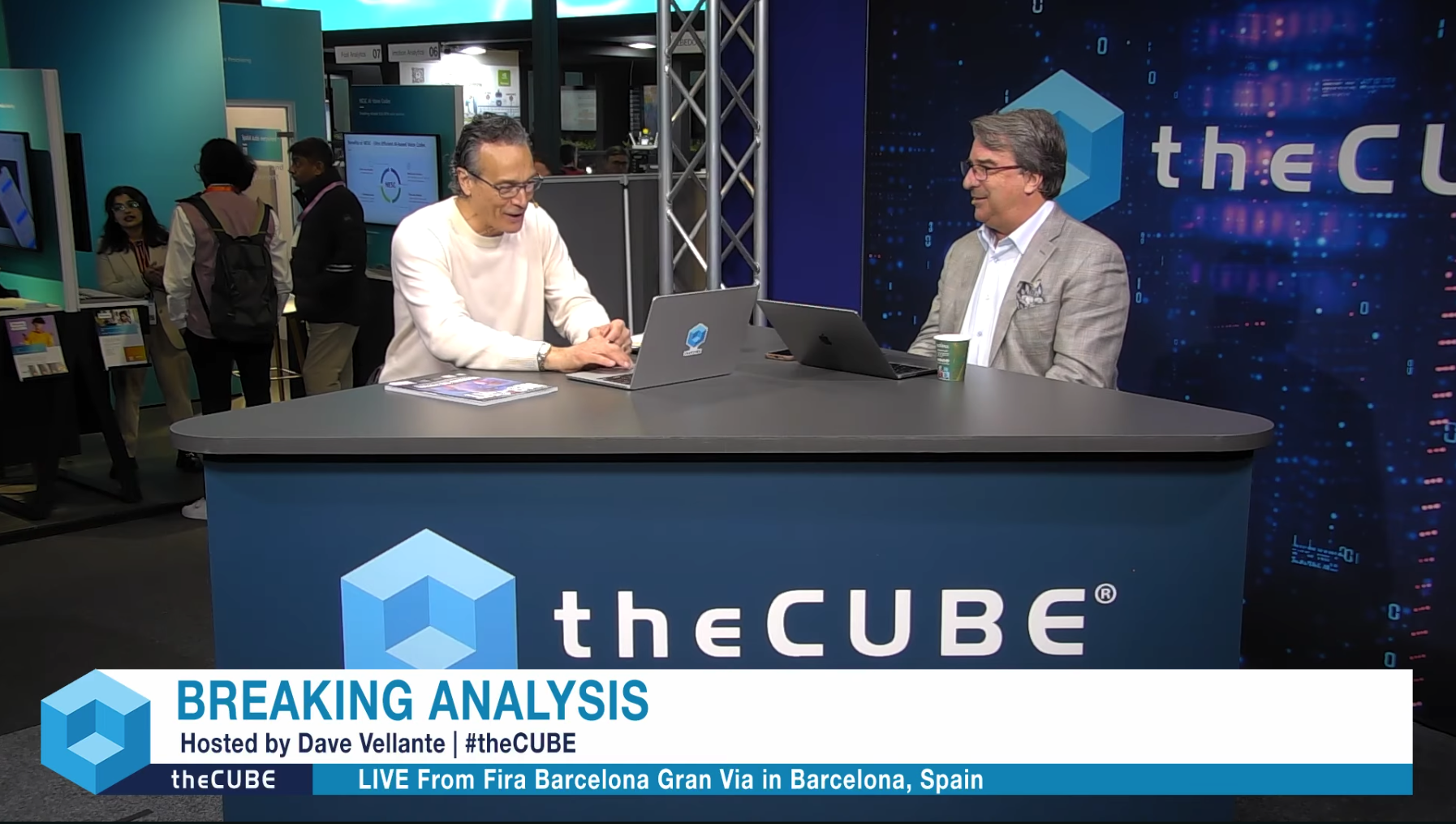 theCUBE discussion set at Mobile World Congress 2026 featuring Dave Vellante and John Furrier.